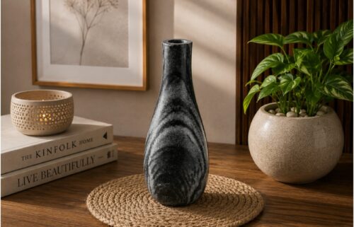 Elegant black marble decorative vase placed on a wooden table in a modern minimalist home interior.