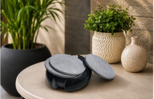 Elegant handcrafted marble coaster set displayed on a modern table with decorative indoor plants, perfect for luxury home décor and tabletop styling.